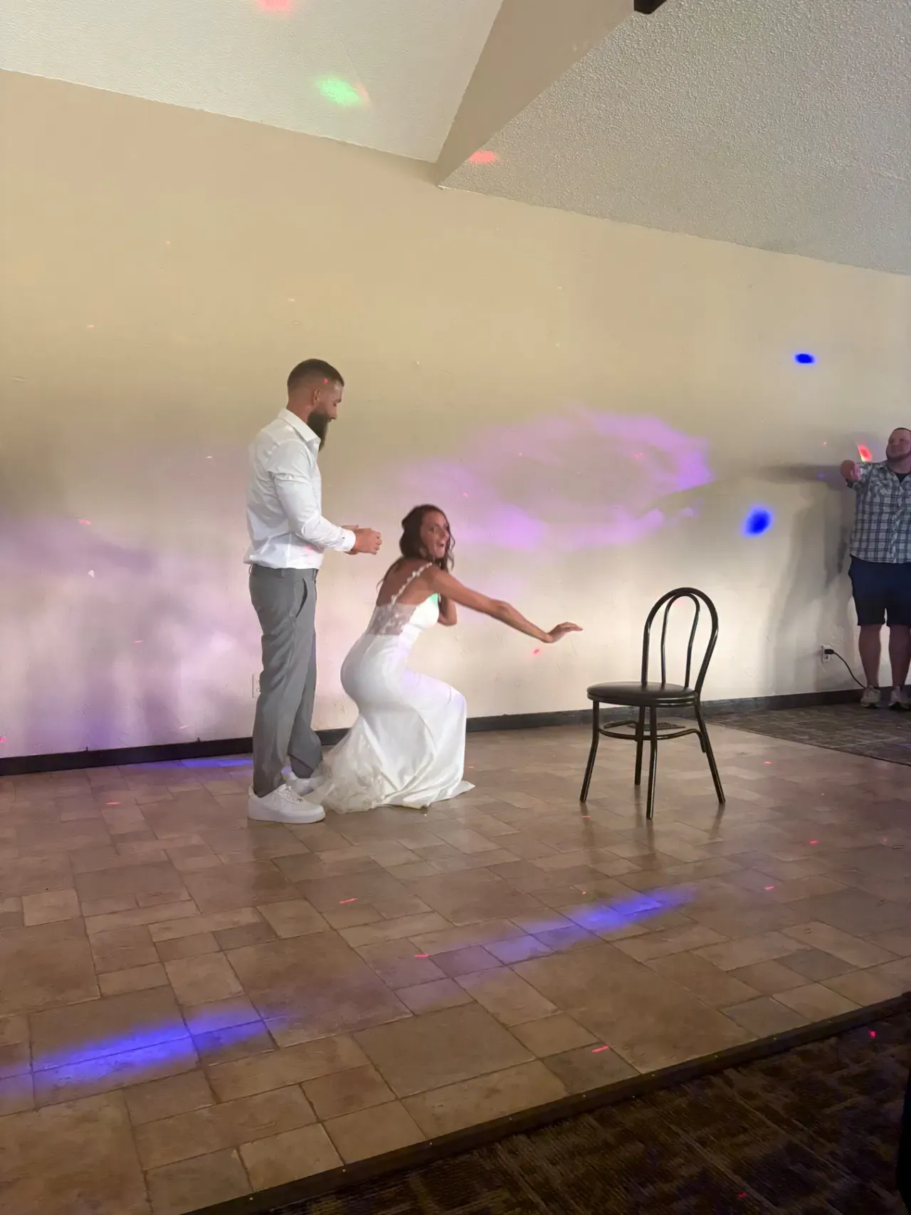 A couple dancing alone on a wide empty dance floor