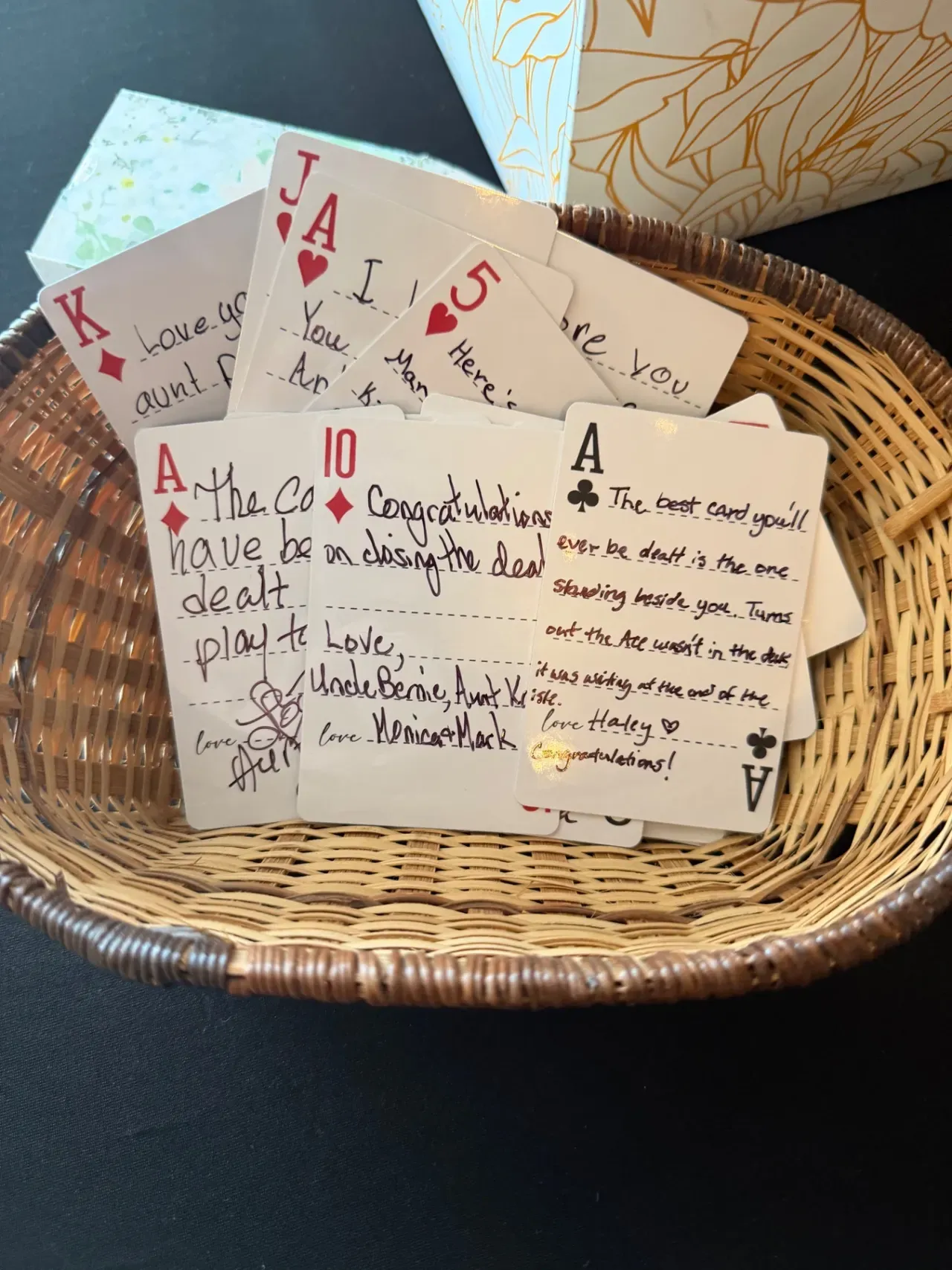 Handwritten well-wishing cards collected in a woven basket